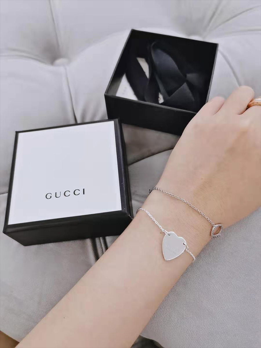 gucci heart bracelet on wrist